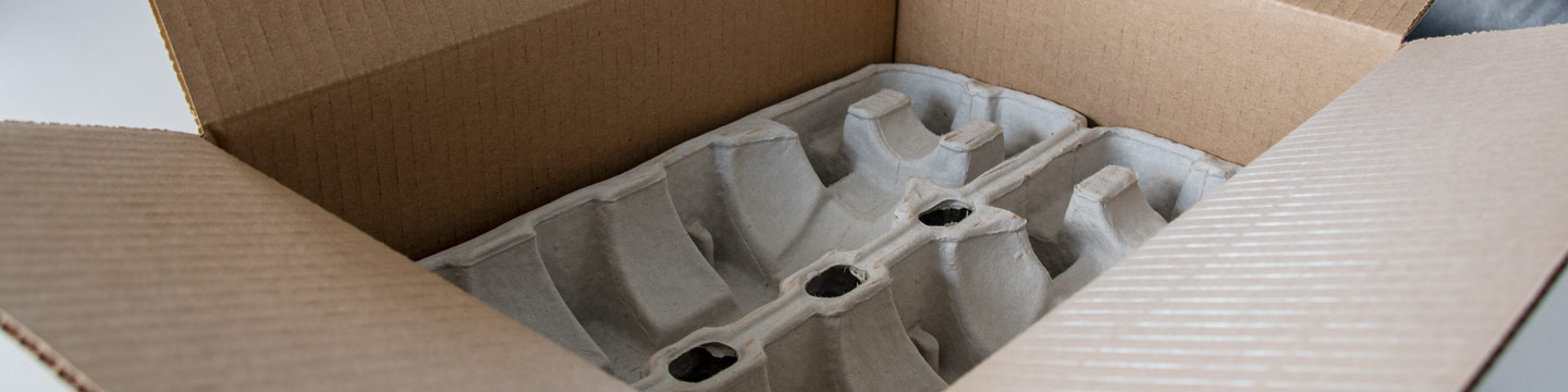 cardboard shipping box with compostable pulp tray inside