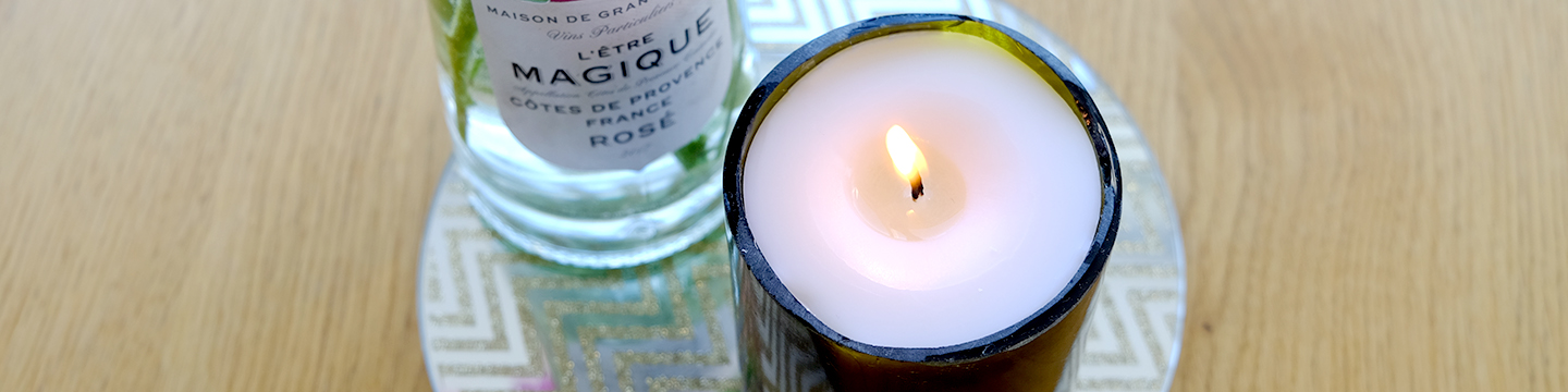 A DIY candle made inside of a class-cut wine bottle.