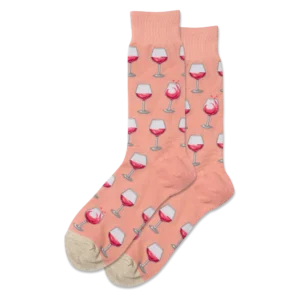 Mens crew socks that are salmon in colour. They have wine glasses printed on them. 